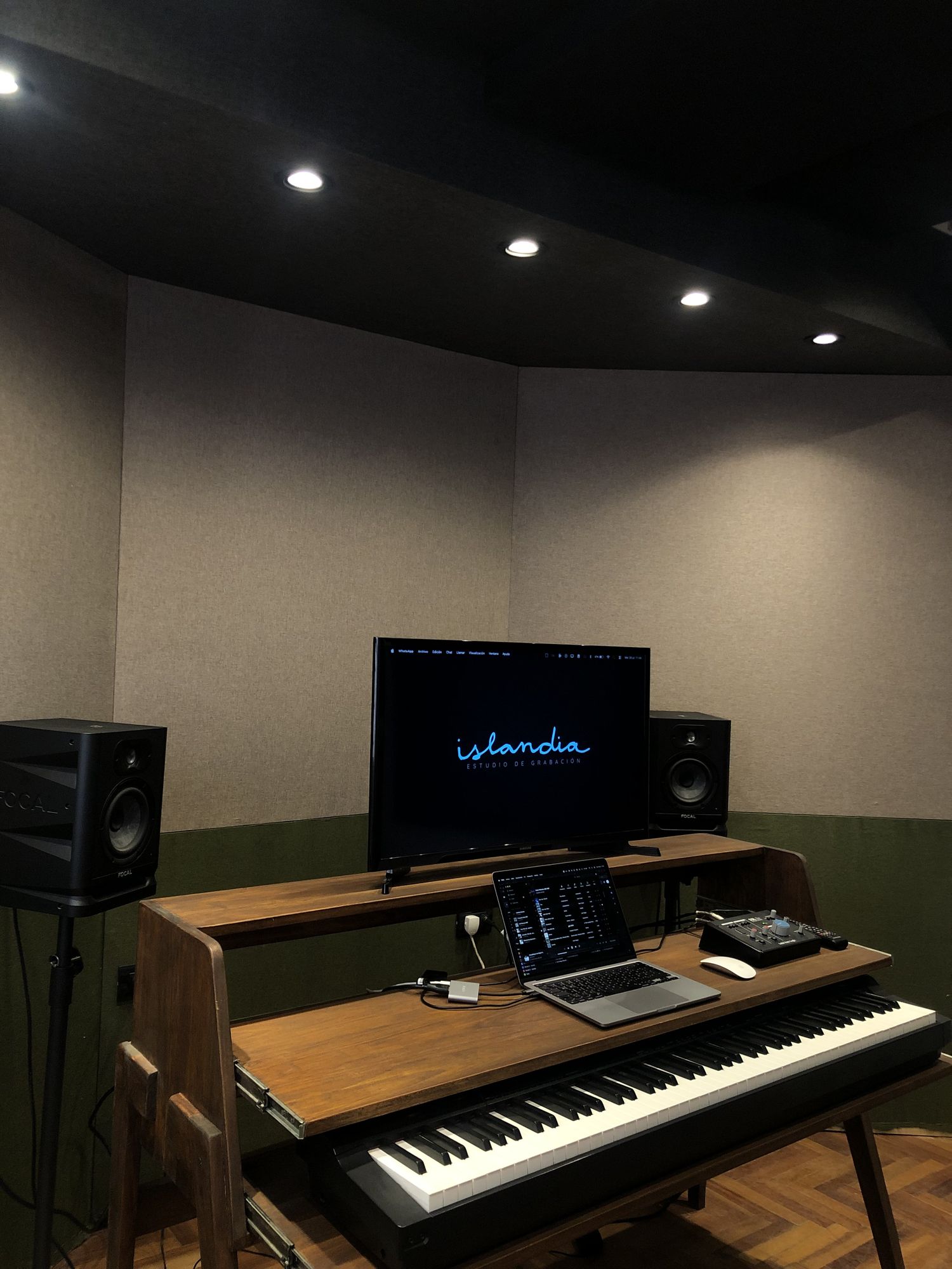 Studio C, with a production desk, piano and Focal monitors